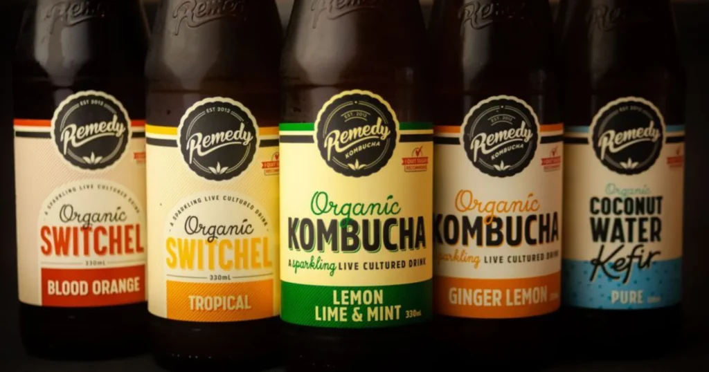 A glass of kombucha with a SCOBY and tea leaves, exploring what science actually says about kombucha benefits for gut health.