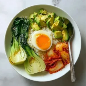 Fermented veggie rice bowl with kimchi, avocado, soft boiled egg and bok choy — a gut healthy meal ready in 20 minutes