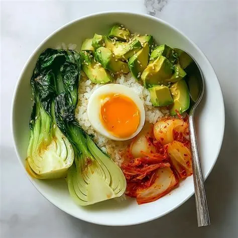 Fermented veggie rice bowl with kimchi, avocado, soft boiled egg and bok choy — a gut healthy meal ready in 20 minutes