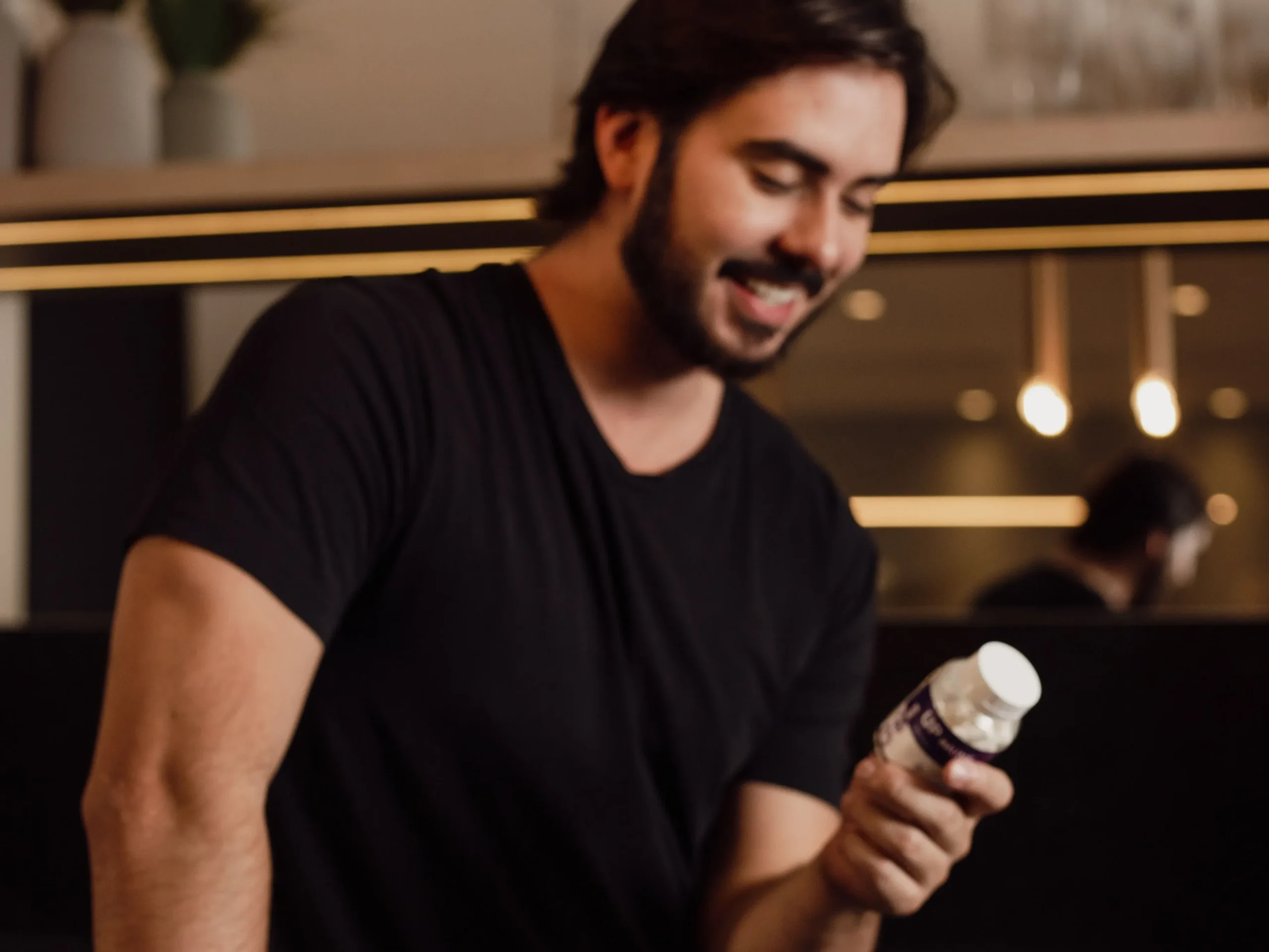 Person happily holding probiotic and prebiotic supplement bottles in a sunny kitchen, concluding the journey to finding the best gut health supplements that work.