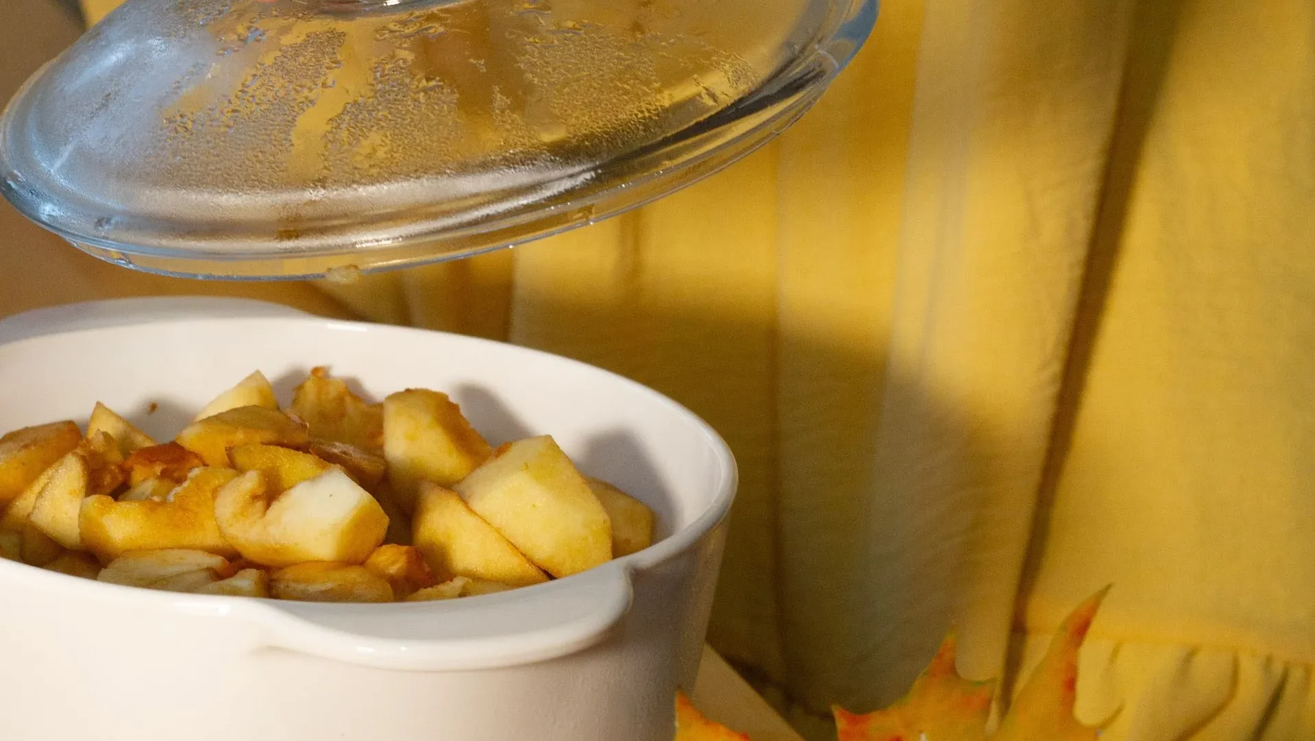 Chopped apples with skin, a cinnamon stick, and a pot ready for cooking, demonstrating the best practices for making stewed apples for gut health.