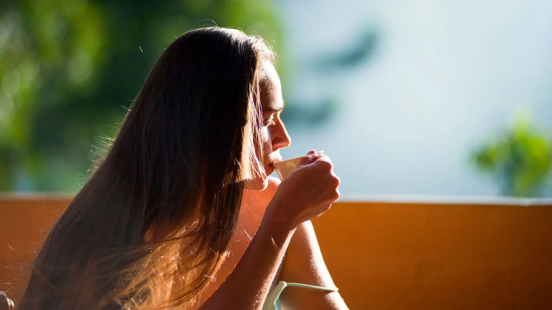 Person happily sipping a gut-friendly beverage, reinforcing the habit of choosing the best drinks for gut health daily for a happier digestive system.