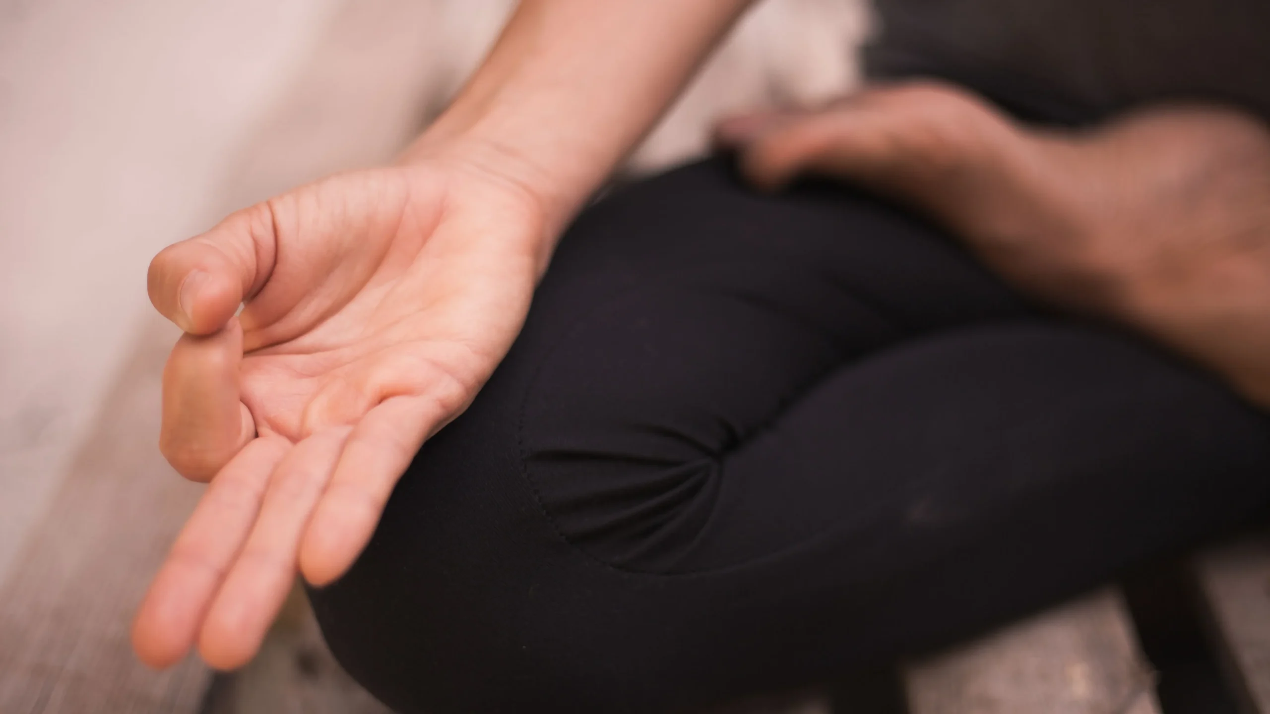 Person in a peaceful seated yoga pose, illustrating how yoga for gut health activates the rest-and-digest response and reduces stress.