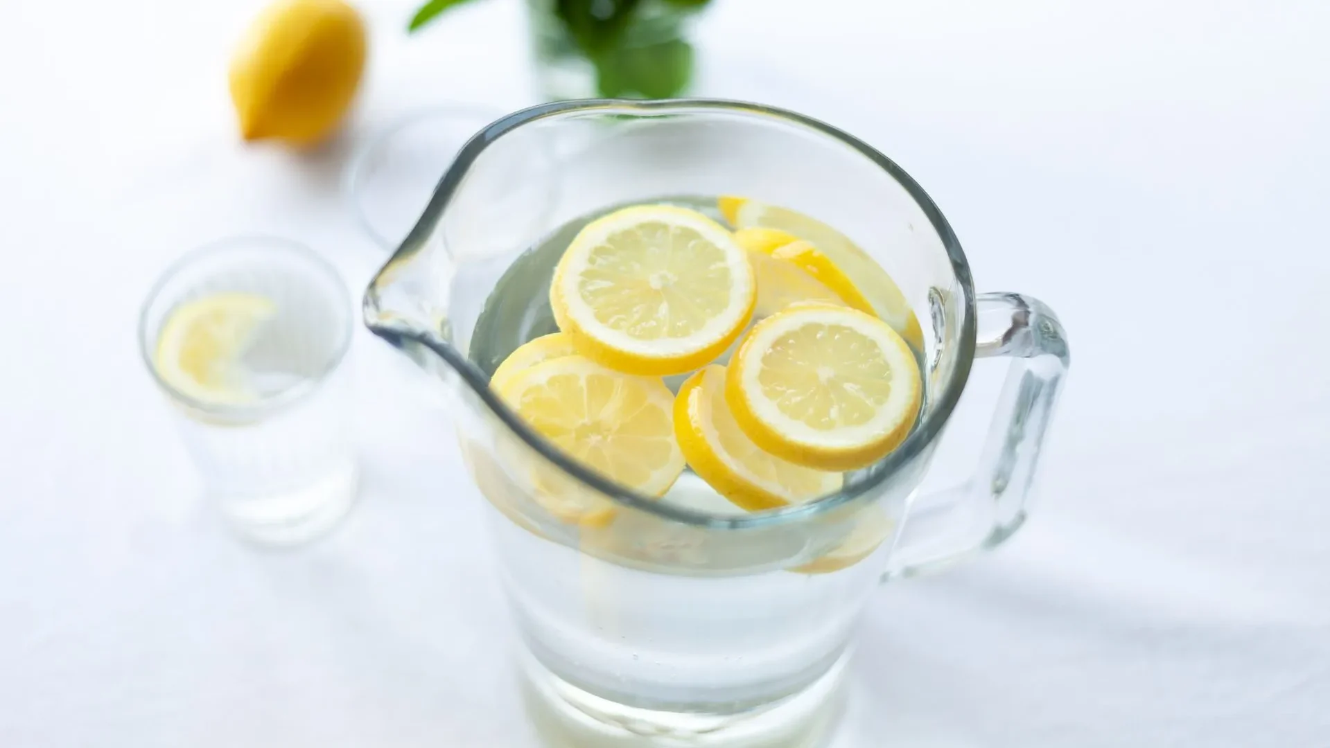 Glasses of water, lemon water, and coconut water, foundational hydrating drinks for gut health essential for digestion and nutrient absorption.