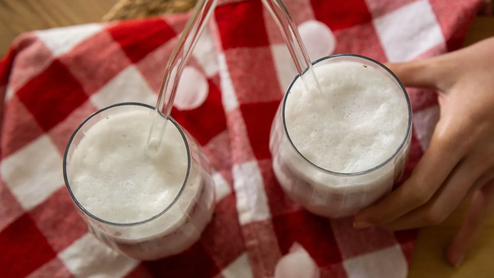 Two glasses of milk kefir and water kefir, showing dairy and non-dairy options among the best drinks for gut health with multiple probiotic strains.