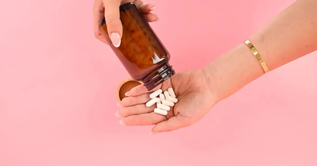 A bottle of collagen peptides next to a glass of water and fresh ingredients, representing the key question: do peptides for gut health actually work?