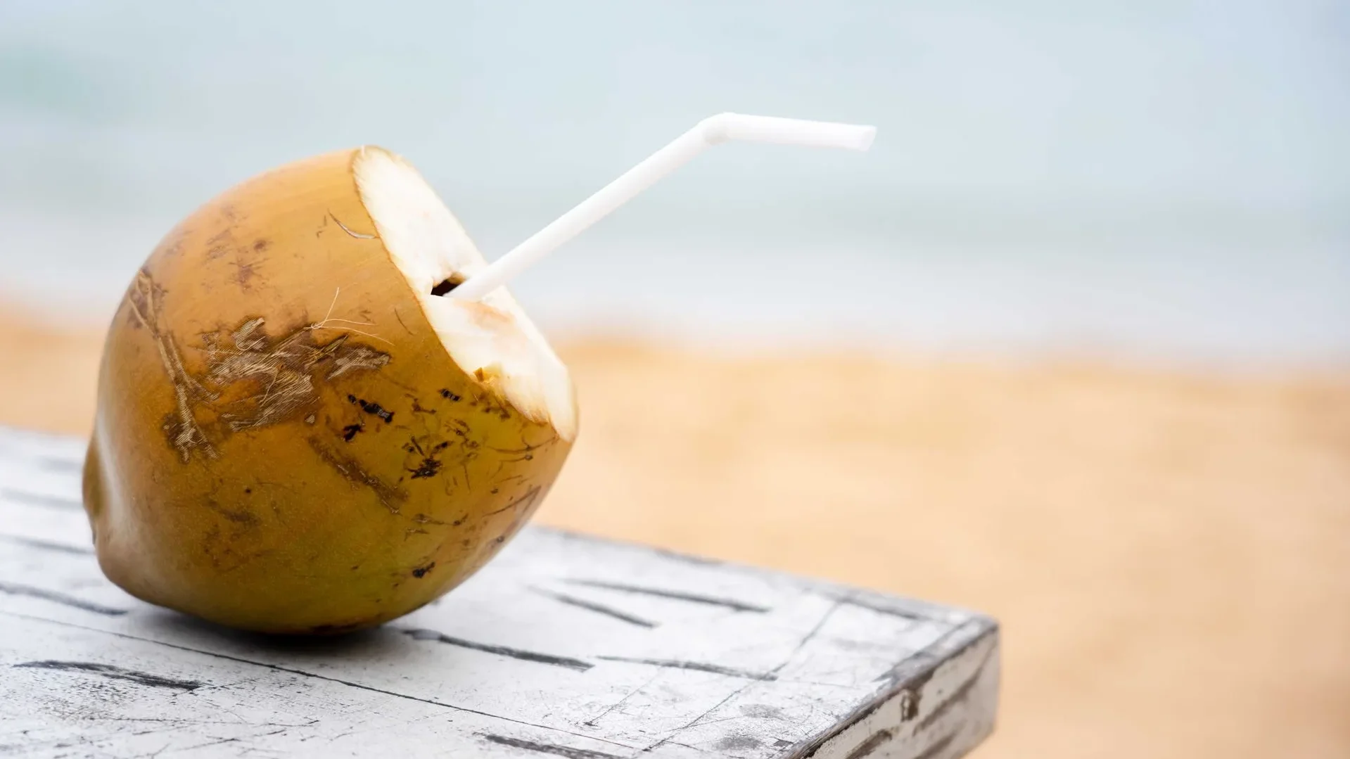 Bottle and glass of probiotic coconut water, combining electrolytes and live cultures in one of the best probiotic drinks for active individuals.