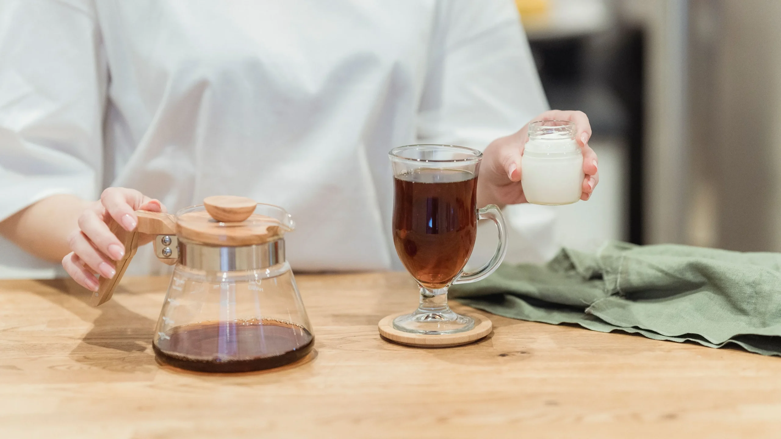 Person sampling different probiotic drinks, including kefir and water kefir, to find the best probiotic drinks that fit their taste and lifestyle