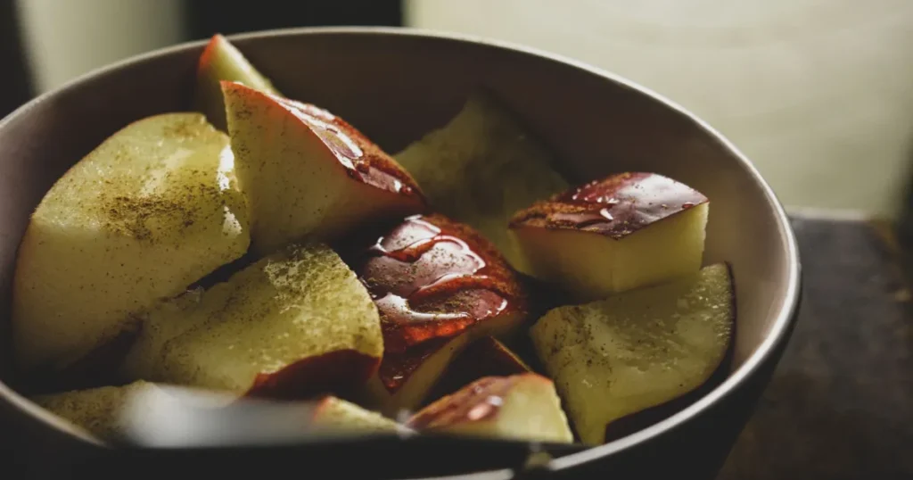 A warm bowl of stewed apples with cinnamon, illustrating the simple, comforting food that supports stewed apples for gut health.