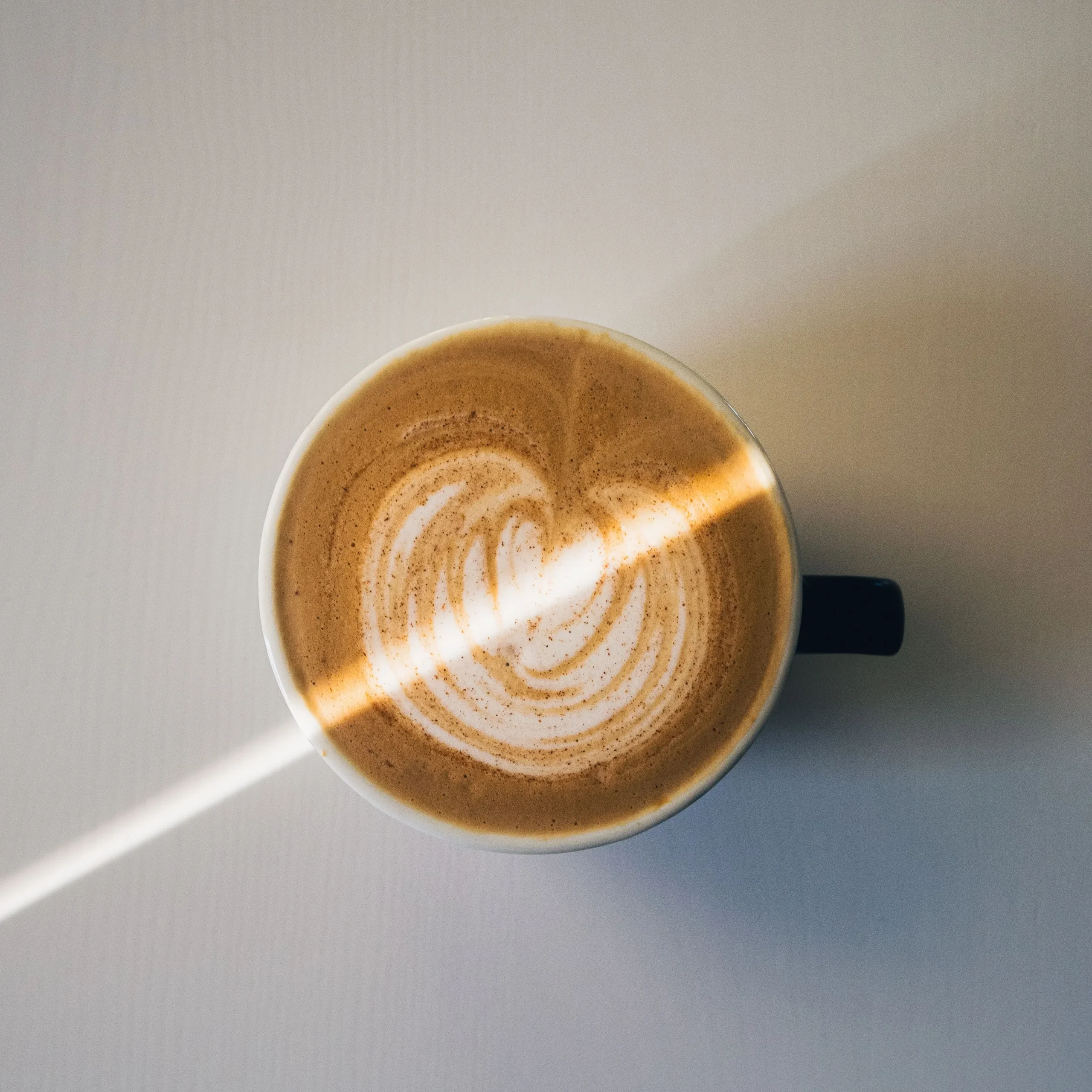 sweetened coffee latte overhead white background