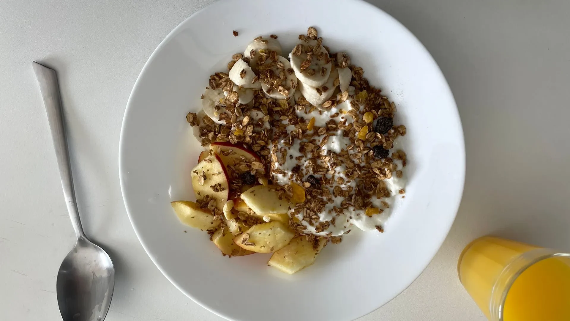 A bowl of stewed apples as part of a balanced breakfast with yogurt and nuts, showing the ideal timing to incorporate stewed apples for gut health into your day.