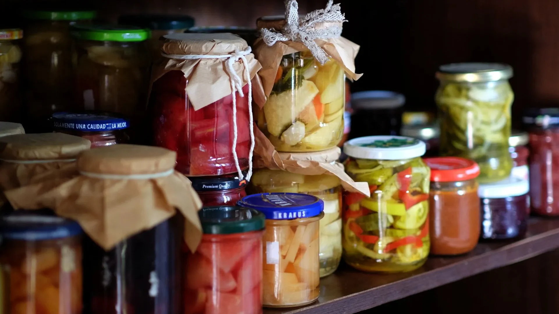 Hand holding a jar of raw sauerkraut with a visible "live cultures" label, showing how to choose a real fermented food vs. a pasteurized imitation.