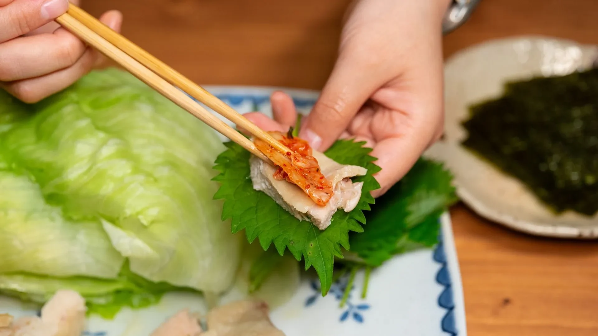 Person gently touching their stomach in comfort after eating, highlighting improved digestion and nutrient absorption as key kimchi benefits for gut health.