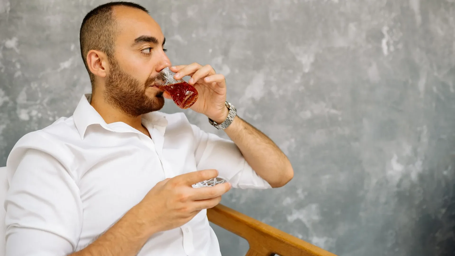 Person drinking kombucha alongside a meal with sauerkraut and kimchi, demonstrating how to incorporate kombucha benefits for gut health into a daily routine.